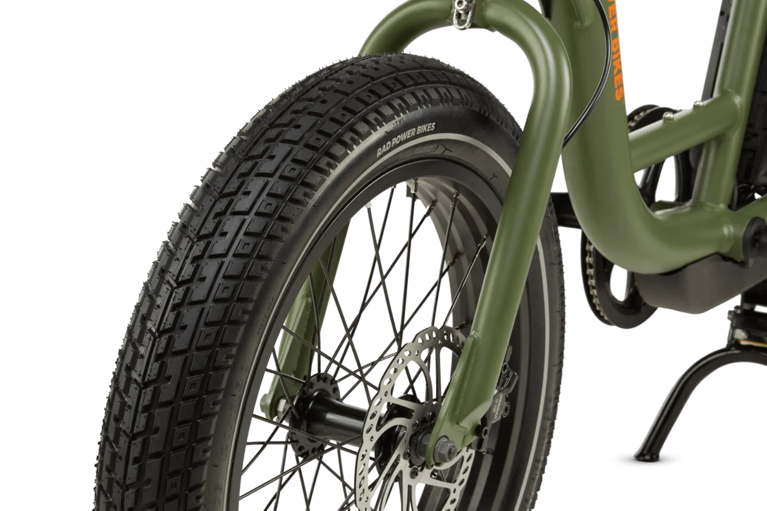 Close-up of a bicycle front wheel, disc rotor, and brake caliper